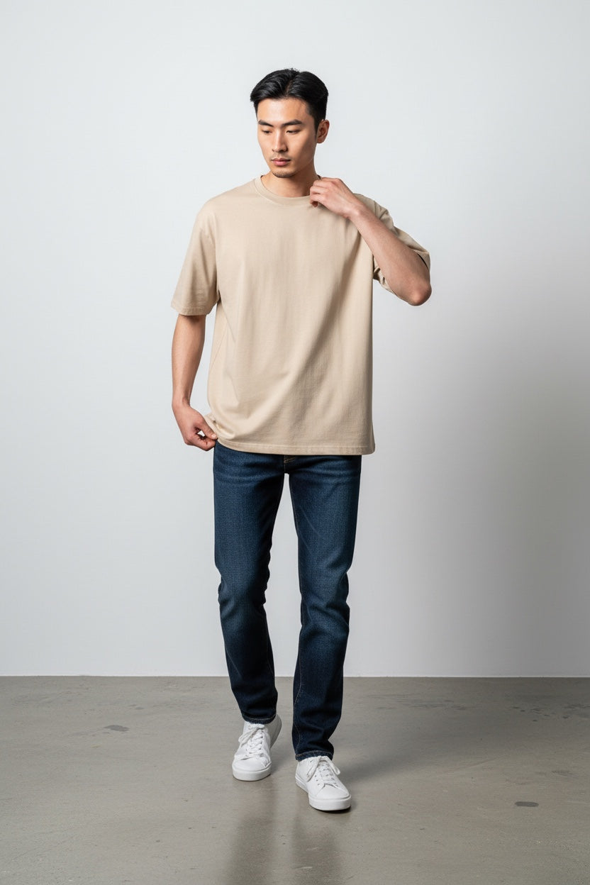 Pavel & Co beige heavyweight cotton French Terry boxy fit t-shirt worn by a model with dark blue jeans