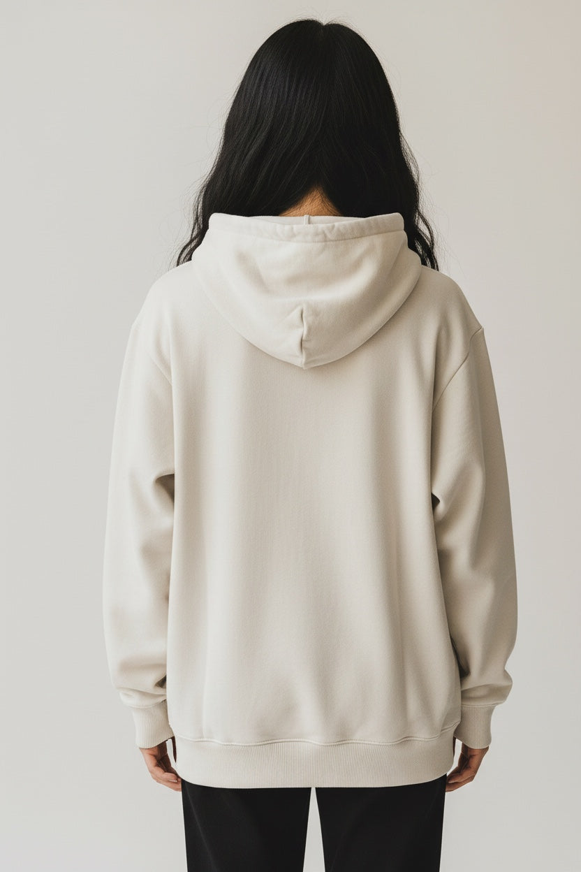 Back view of a person wearing a beige Pavel & Co oversized heavyweight cotton-blend hoodie with ribbed hem and cuffs.