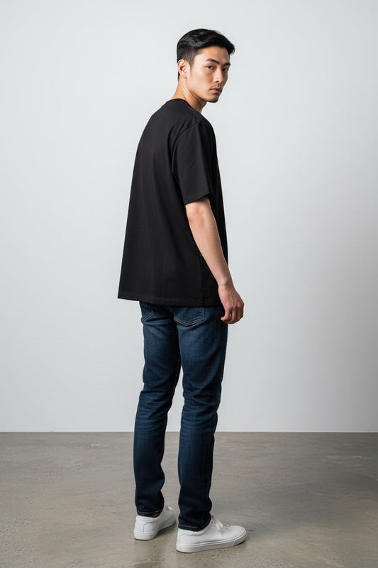 Pavel & Co black boxy fit heavyweight cotton French Terry t-shirt worn by a man, showing a dropped shoulder silhouette