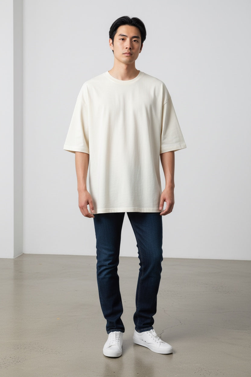 Model wearing a Pavel & Co Metropolis boxy fit heavyweight cotton French Terry t-shirt in off-white with drop shoulders