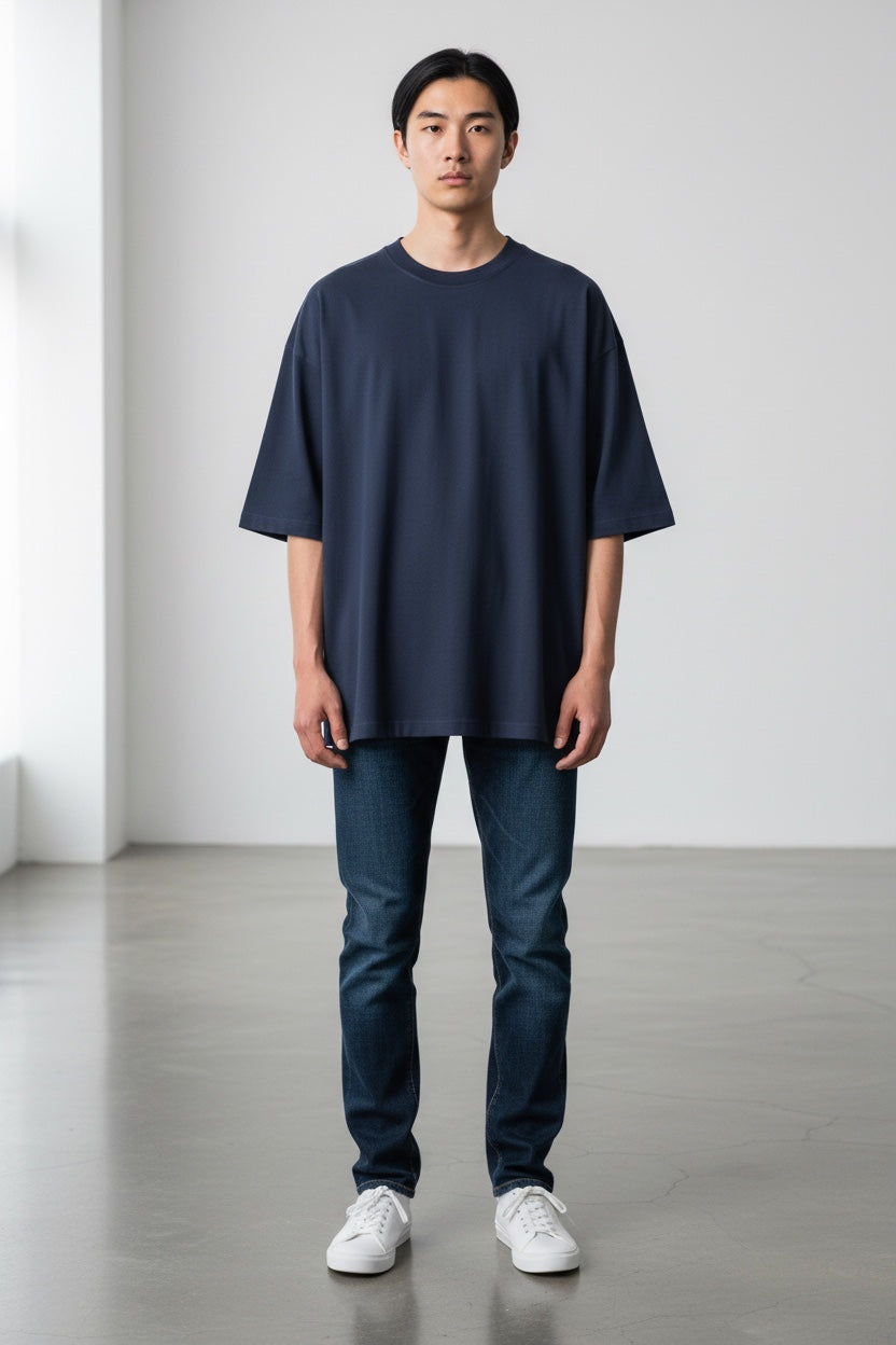 Model wearing a navy Pavel & Co Metropolis boxy fit t-shirt in heavy cotton French Terry with dropped shoulders.