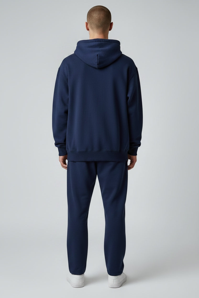 Back view of a man wearing a Pavel & Co navy blue oversized heavyweight cotton-blend hoodie with ribbed trim.