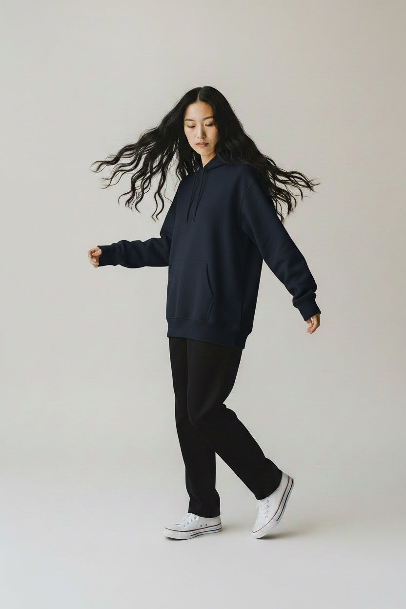 Pavel & Co navy blue oversized heavyweight cotton-blend hoodie worn by a woman with long hair on a neutral background