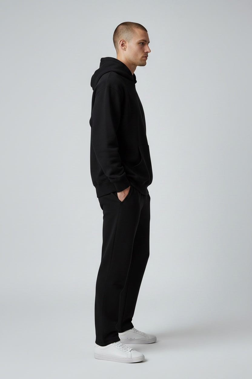 Pavel & Co oversized black heavyweight cotton-blend hoodie with dropped shoulders and kangaroo pocket, side view.